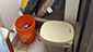 This bucket, which was not frozen likely due to the use of saltwater, was used in place of the frozen toilet.